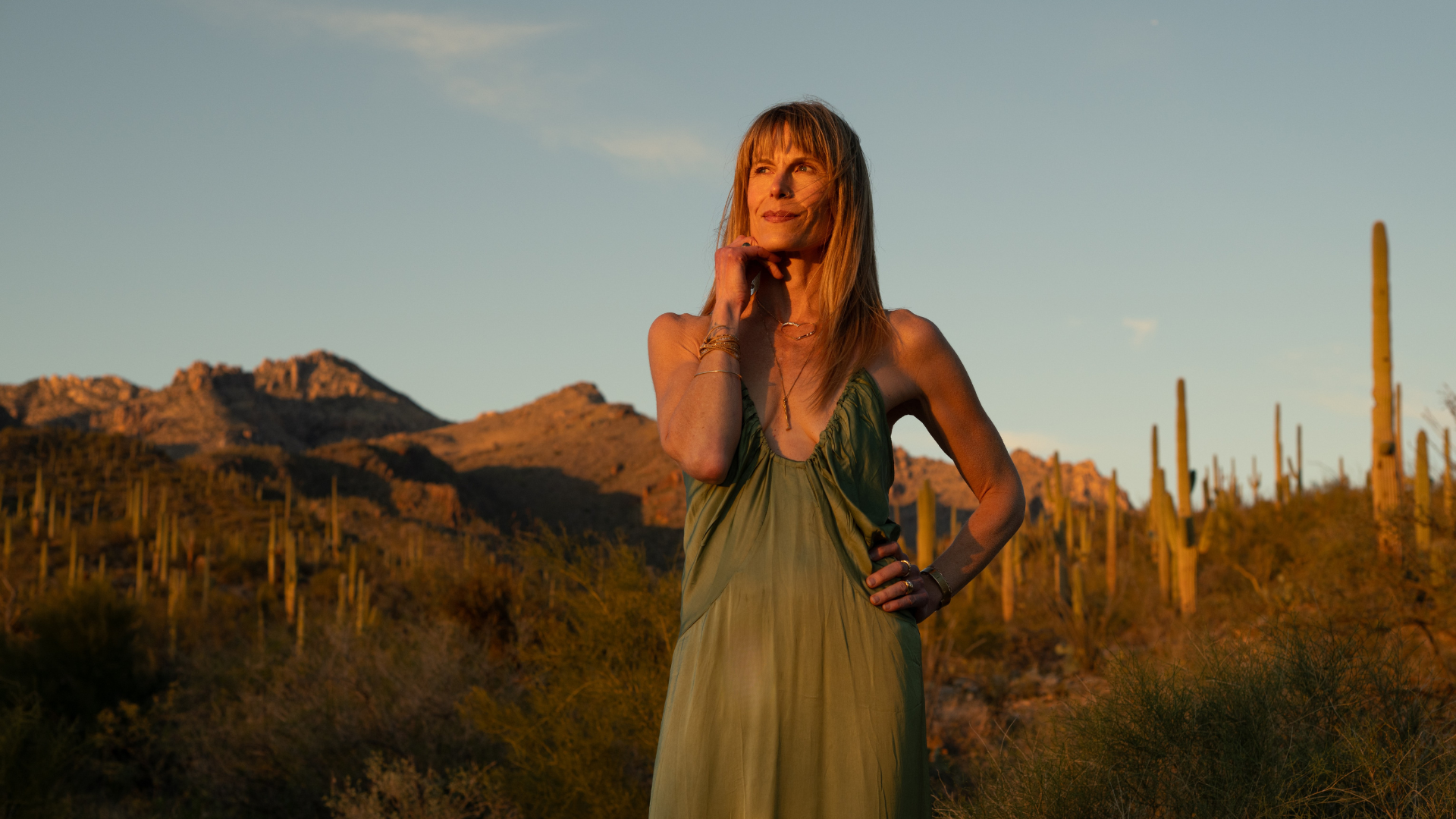 Kristy Scher smiling in the Sonoran desert at golden hour